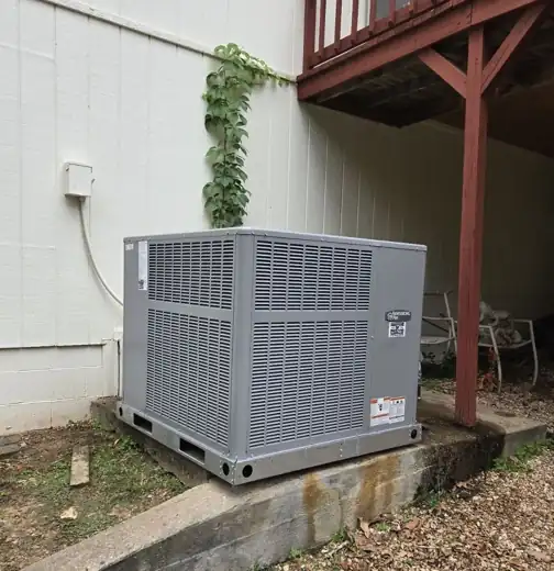 Packaged unit on a concrete pad under a deck